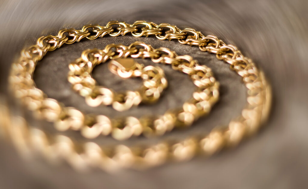 Velor background with gold chain. Brown background.